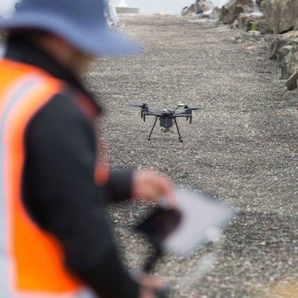 An operator prepares to launch a drone.